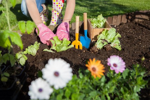 Seasonal garden maintenance tasks in Raynes Park including pruning and weeding